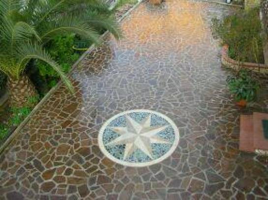 Crazy Paving in  slabs of porphyry  with compass rose.